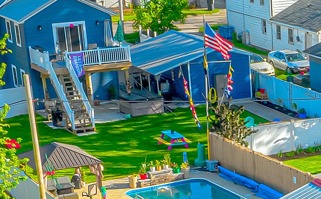 Aerial view of heated pool, gazebo and tiki bar